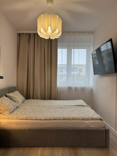 Ένα ή περισσότερα κρεβάτια σε δωμάτιο στο RETKINIA Apartament