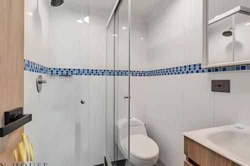 a bathroom with a toilet and a glass shower at Paola 201 - Charm and perfect location in Laureles in Guayaquil