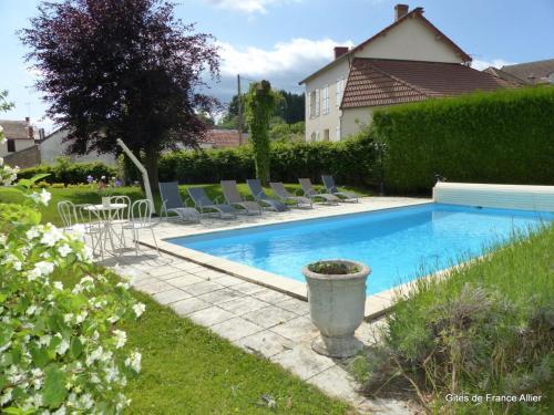 - une piscine avec des chaises longues dans la cour dans l'établissement Grande maison contemporaine avec piscine privée, proche lac, randonnées et activités de loisirs - FR-1-489-134, à Mayet-de-Montagne