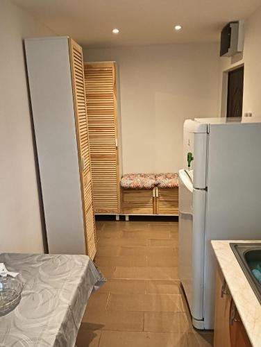 a small kitchen with a refrigerator and a table at Intim apartament in Galaţi