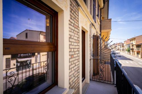 a balcony with a window with a view of a street at Garden apartment, wifi and private parking in Porto SantʼElpidio