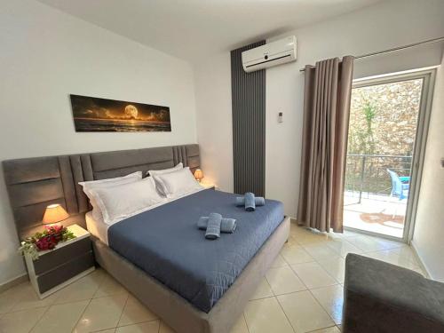 a bedroom with a bed with two towels on it at Ksamil Apartament Sela in Ksamil