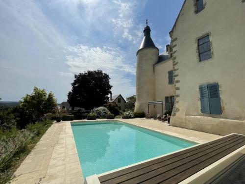 a house with a swimming pool next to a building at Demeure de caractère avec piscine et parking, animaux admis, wifi - FR-1-489-457 in Vernusse