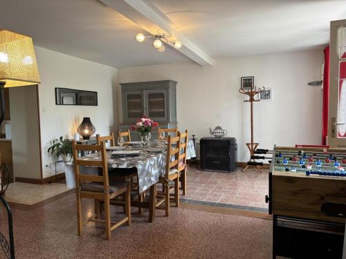 a dining room with a table with chairs and a chessboard at Fermette rénovée avec jardin clos, animaux acceptés, WiFi et parking - FR-1-489-87 in Bourbon-lʼArchambault