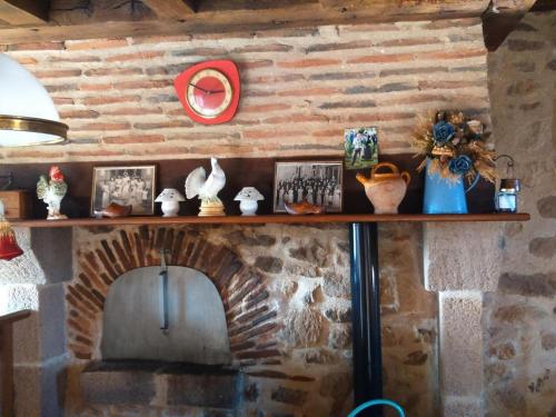 a brick fireplace with a shelf on a wall at Maison en pierre rénovée avec étang, pêche, jardin et BBQ, proche Forêt de Tronçais - FR-1-489-293 in Bourbon-lʼArchambault