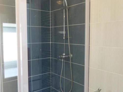a shower with a glass door in a bathroom at Maison de vacances rénovée avec jardin, idéale famille, proche RCEA, équipée confort et tout inclus - FR-1-489-44 in Cressanges