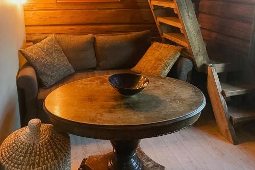 a living room with a couch and a table at Historic Cabin By The Ski Trail In Østmarka in Omberg
