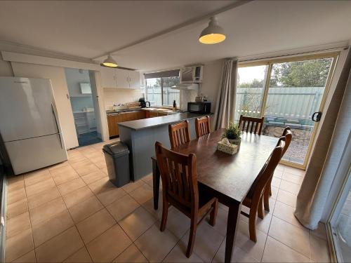 a kitchen and dining room with a table and chairs at 3 by the Sea at Coobowie Unit 3 in Coobowie