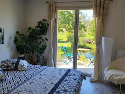 a bedroom with a bed and a sliding glass door at Refuge familial avec piscine, aire de jeux et confort moderne à Blomard - FR-1-489-465 in Blomard