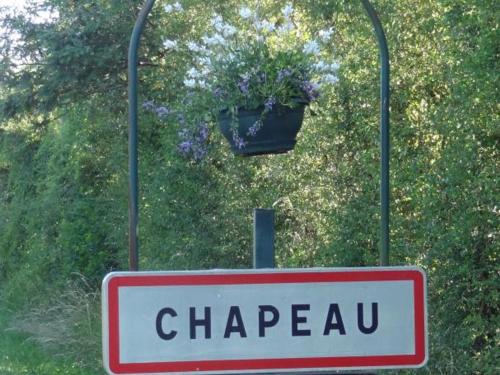 a sign that says chappu and a hanging flower pot at Gîte rénové à Chapeau avec wifi, terrasse et parking - FR-1-489-269 in Chapeau