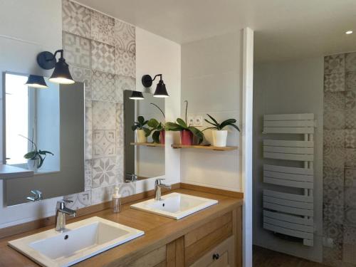 a bathroom with two sinks and a mirror at Gîte nature à St Léon avec jardin et WIFI - FR-1-489-440 in Saint-Léon