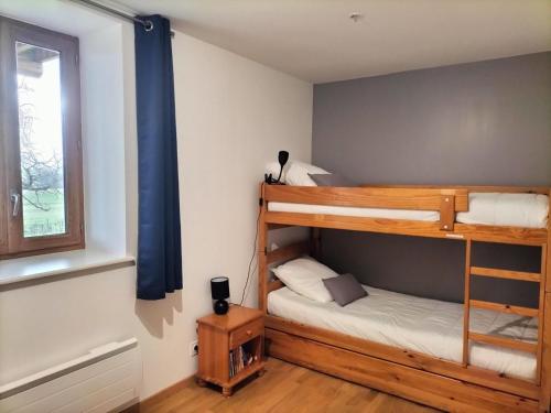 a bedroom with two bunk beds and a window at Gîte nature à St Léon avec jardin et WIFI - FR-1-489-440 in Saint-Léon