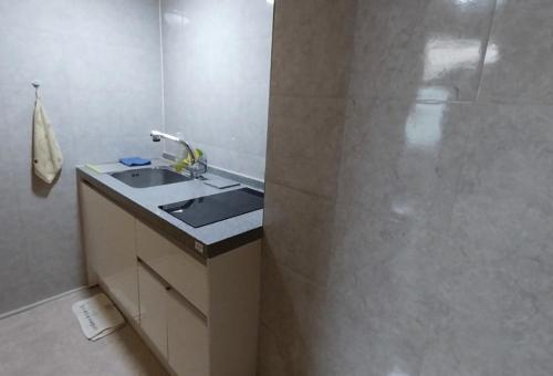 a bathroom with a sink and a shower at Haneul Cheon Ddaji Hanok in Yangyang