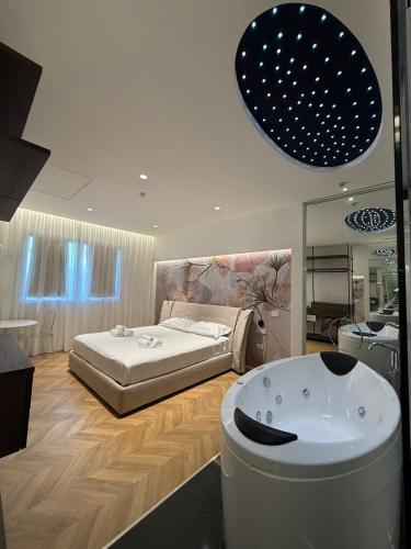 a bedroom with a bed and a bath tub at Saretta Luxury Suites in Cagliari