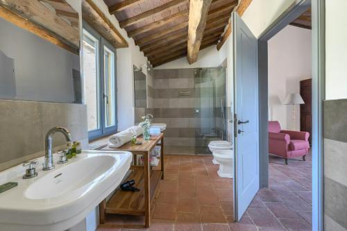 a bathroom with a sink and a toilet at Historic Villa Overlooking Val D'orcia in Buonconvento