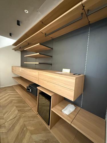 a desk in a room with wooden shelves at Saretta Luxury Suites in Cagliari