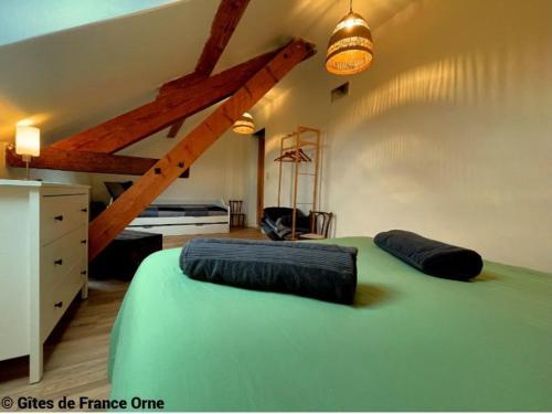 a bedroom with a large green bed and a dresser at Gîte paisible en Normandie avec WiFi, animaux admis - FR-1-497-227 in La Trinité-des-Laitiers