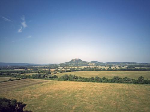 a view of a mountain from a field at Bazaltorgona Apartman in Kisapáti
