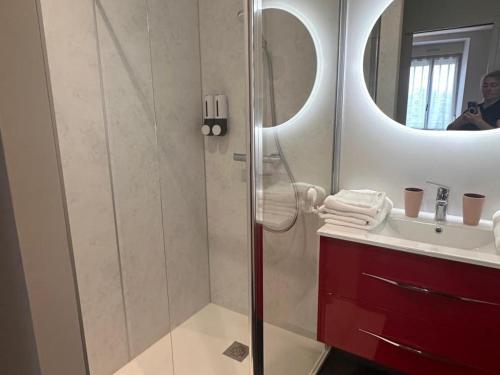 a bathroom with a shower with a sink and a mirror at Gîte élégant avec piscine partagée et jardin, proche Bagnoles de l'Orne - FR-1-497-199 in La Chapelle d'Audaine