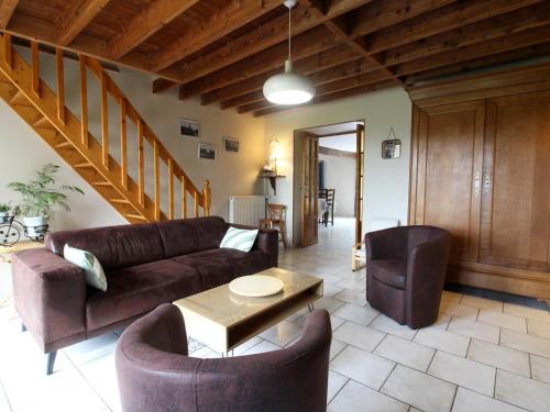 a living room with a couch and chairs and a table at Maison de charme avec jardin, nature, cheminée, WiFi, proche manoirs et rivières tortueuses - FR-1-497-99 in Saint-Bômer-les-Forges