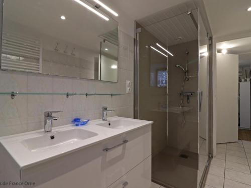 a white bathroom with a sink and a shower at Maison de charme avec jardin, nature, cheminée, WiFi, proche manoirs et rivières tortueuses - FR-1-497-99 in Saint-Bômer-les-Forges