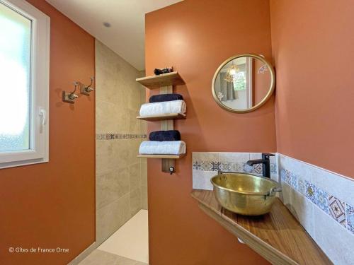 a bathroom with a sink and a mirror at Maison en Pierre avec Jardin, Séances Bien-Être et Activités Nature - Pays du Poiré, Normandie - FR-1-497-208 in Mantilly