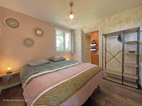 a bedroom with a large bed and a window at Maison en Pierre avec Jardin, Séances Bien-Être et Activités Nature - Pays du Poiré, Normandie - FR-1-497-208 in Mantilly