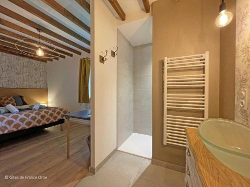 a bathroom with a sink and a bedroom with a bed at Maison en Pierre avec Jardin, Séances Bien-Être et Activités Nature - Pays du Poiré, Normandie - FR-1-497-208 in Mantilly