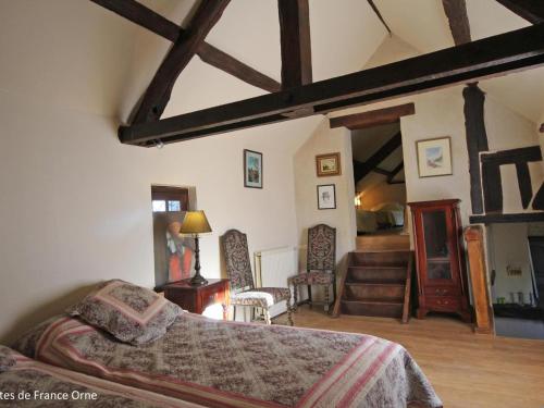a bedroom with a bed and a living room at Charmant Gîte de Chasse avec Grand Jardin, WIFI, Cheminée, et Confort Moderne - Animaux Acceptés - FR-1-497-166 in Le Chêne dʼAuvilliers