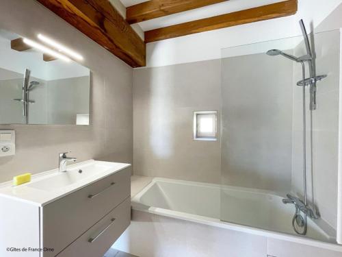 a bathroom with a tub and a sink and a shower at Charmante maison en pierres restaurée, WIFI, 2 ch. - FR-1-497-241 in La Mesniere