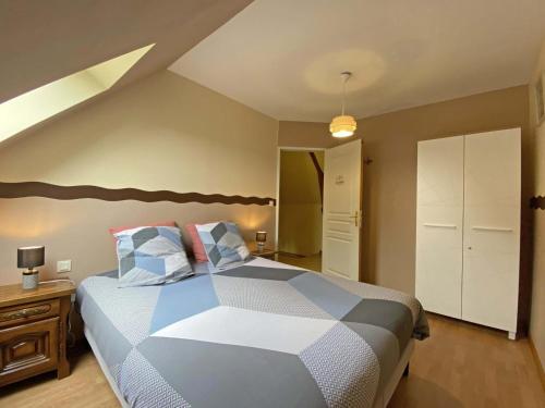 a bedroom with a large bed with pillows on it at Maison de caractère avec jardin, idéale pour famille, animaux acceptés, randonnée, loisirs à proximité - FR-1-497-161 in Saint-Germain-de-Martigny