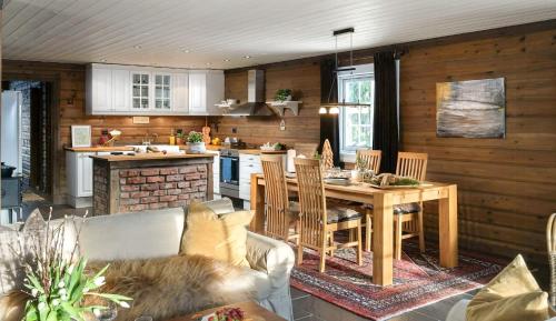 a kitchen and dining room with a table and chairs at Family Cabin With Shelter By Lake Gautetjern in Gol