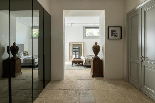 a hallway with a room with a bed and a mirror at La Dépendance Hotel in Noto
