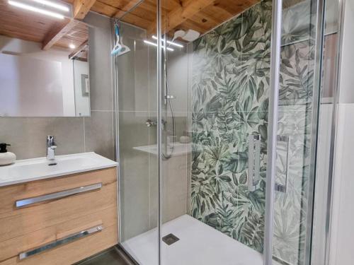 a bathroom with a shower with a glass door at Gîte spacieux 10 pers: Nature, Spa, Confort - FR-1-496-358 in Saint-Denis-sur-Coise