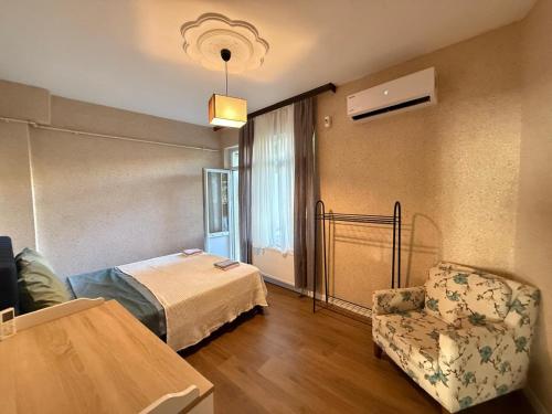 a room with a bed and a chair and a window at The istanbul Arnia Apartment in Istanbul