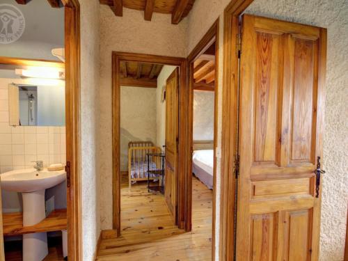a bathroom with a wooden door and a sink at Chalet familial à 5 min des pistes de ski de Chalmazel, 3 chambres, cheminée, animaux acceptés - FR-1-496-138 in Le Champas