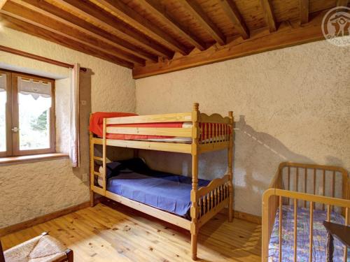 a bedroom with two bunk beds in a room at Chalet familial à 5 min des pistes de ski de Chalmazel, 3 chambres, cheminée, animaux acceptés - FR-1-496-138 in Le Champas