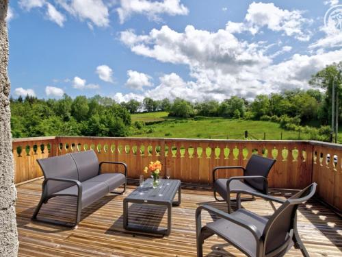a deck with chairs and a table and a couch at Gîte de charme avec spa, terrasse et balcon - Tout confort, au cœur de la nature - FR-1-496-303 in Pouilly-les-Feurs