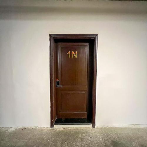a wooden door with the letter n on it at Superior Furnished Apartments شقق مخدومة فاخرة in Jeddah