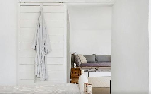 a bedroom with a sliding door with a bed in it at Sea View And Idyll In Bungenäs On Gotland in Fårösund