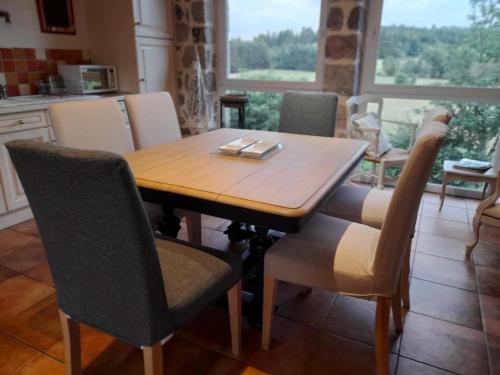 a wooden table and chairs in a kitchen at Gîte chaleureux avec poêle à bois, terrasse, wifi, proche activités nature - FR-1-496-268 in Saint-Régis-du-Coin