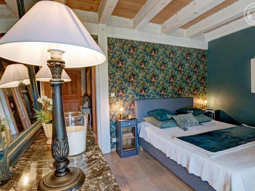 a bedroom with a bed and a table with a lamp at Gîte chaleureux avec poêle à bois, terrasse, wifi, proche activités nature - FR-1-496-268 in Saint-Régis-du-Coin
