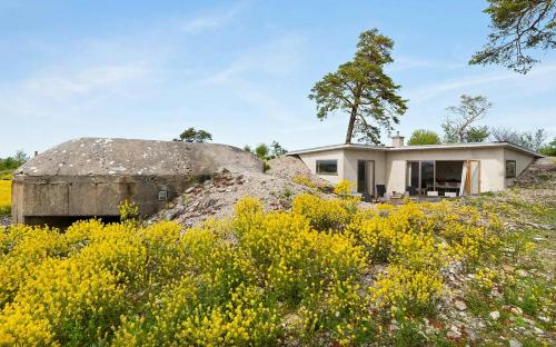 a house on top of a hill with yellow flowers at Sea View And Idyll In Bungenäs On Gotland in Fårösund