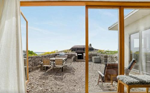 a view of a patio from the window of a house at Sea View And Idyll In Bungenäs On Gotland in Fårösund
