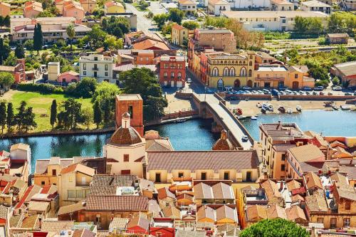 an aerial view of a town with a river and buildings at FIORELLI rooms in Bosa