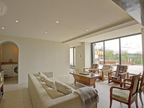 a living room with a couch and a table at Maison mitoyenne spacieuse avec jardin, terrasse et internet - FR-1-496-312 in Saint-Symphorien-de-Lay