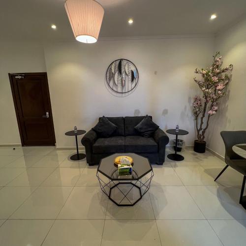 a living room with a couch and a table at Superior Furnished Apartments شقق مخدومة فاخرة in Jeddah
