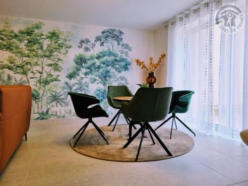 a dining room with green chairs and a table at Maison spacieuse avec jardin, près de Disneyland et Reims, idéale pour familles et amis - FR-1-532-22 in Viels-Maisons