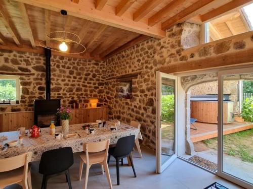 a dining room with a table and chairs at Spacieux gîte avec bain nordique et wifi à Usson-en-Forez - FR-1-496-359 in Usson-en-Forez
