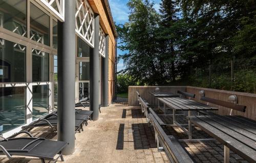 a row of benches sitting outside of a building at Five Bedroom Beautiful Home In Sindal in Sindal